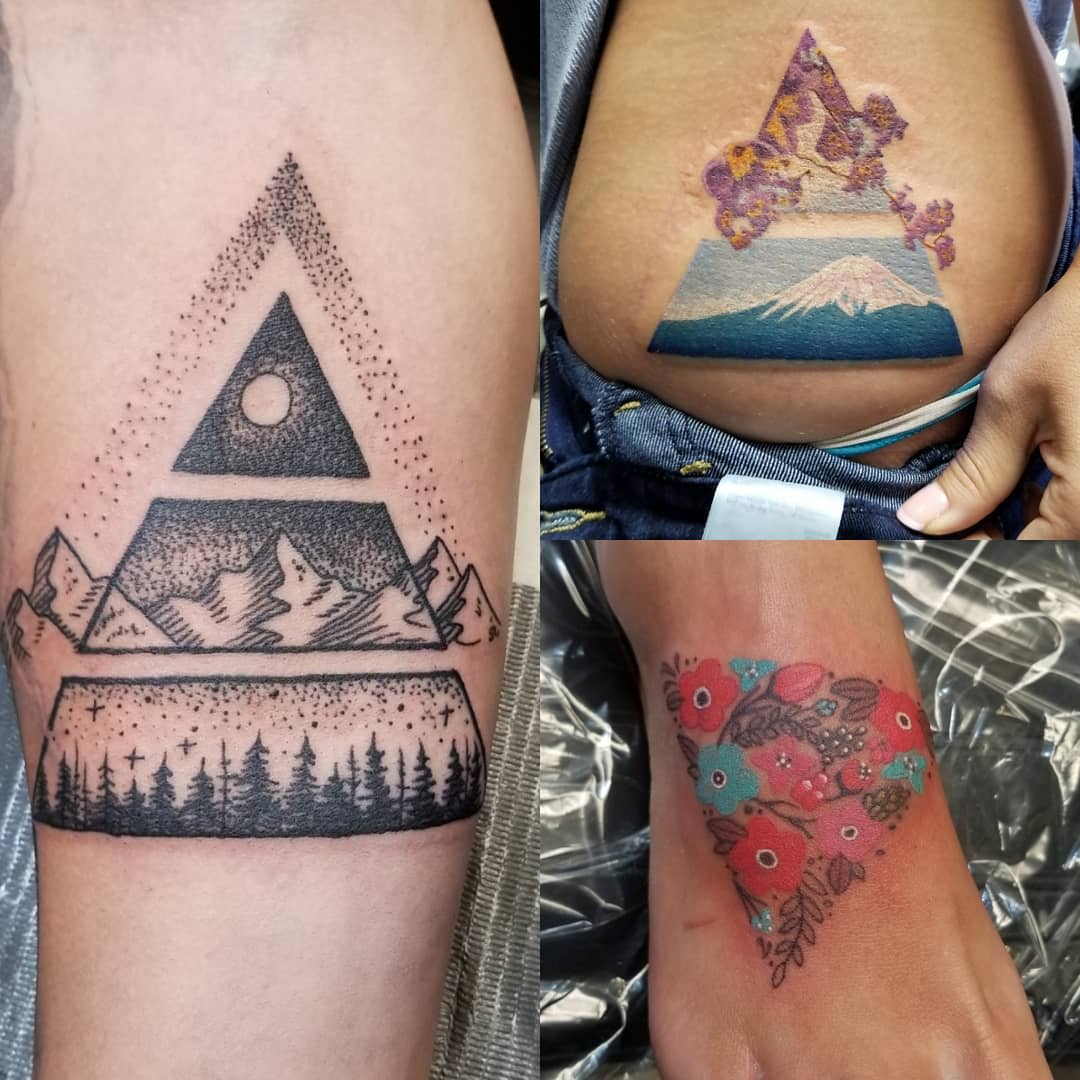 Three triangle tattoos: one with a black and white mountain landscape, another with a colorful mountain and flowers, and the third with a vibrant floral bouquet